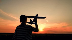Child girl throws toy airplane with his hand. Child playing with toy airplane. Happy girl throws toy airplane into sky flying under sun rays. Little girl wants to become pilot fly travel. Slow motion - Powered by Shutterstock - Get 15% off with code: PIKWIZARD15