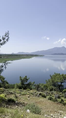 Reflection of mountains and clouds on calm lake