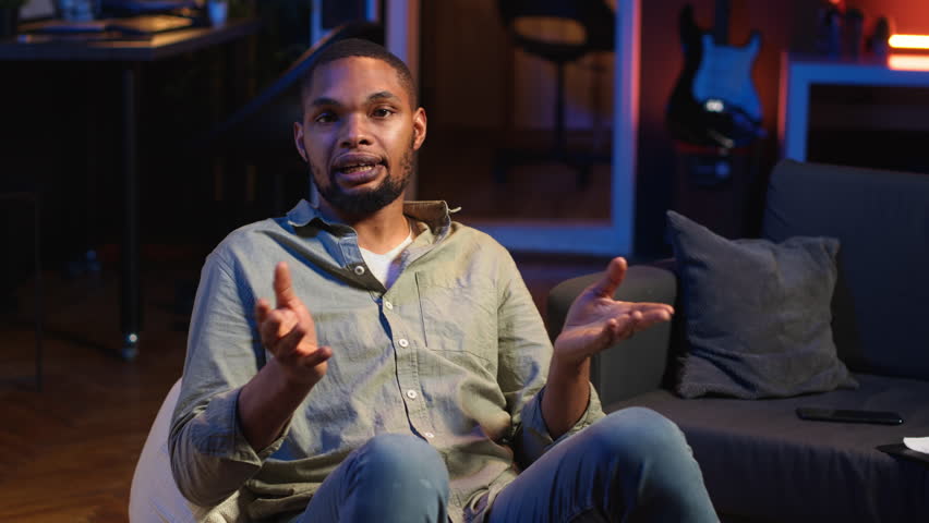 Young adult attending an online class via video conference on internet, meeting with a teacher for important virtual lesson. Black guy studying hard for his master degree remotely. Camera B.