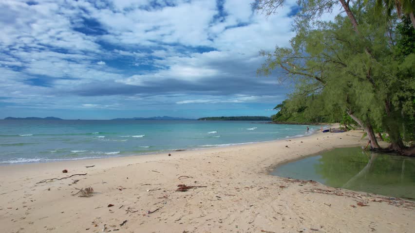 Aerial drone shot above the Andaman Sea paradise island. Drone POV capture turquoise water and tropical landscape showing beauty of summer vacation in serene holiday destination of Koh Kood, Thailand.