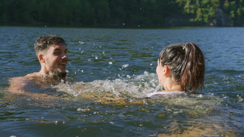 A joyful swim in a serene lake during a getaway.