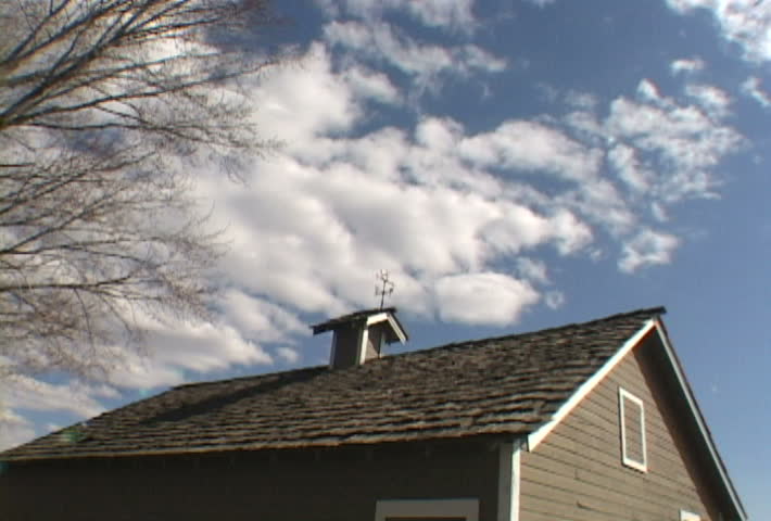 Small barn in Washington on beautiful spring day, clouds pass in Time Lapse.