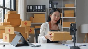 Small business entrepreneur processing online orders, packaging parcels with digital tools while managing e commerce operations from compact home workspace - Powered by Shutterstock - Get 15% off with code: PIKWIZARD15