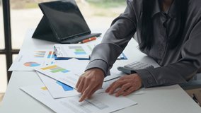 Professional businesswoman analyzing financial documents, calculating data on tablet, reviewing comprehensive business information at modern office workspace - Powered by Shutterstock - Get 15% off with code: PIKWIZARD15