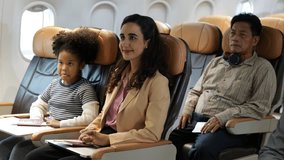 Passenger : African American sister and little girl traveling by an airplane. serving drinks.  Female steward serving glass of water for passengers on board. Flight attendant  and Cart on airplane - Powered by Shutterstock - Get 15% off with code: PIKWIZARD15