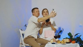 Young woman shows a gift from her boyfriend and is happy with the gift. A young couple is talking to friends on a c using a phone while celebrating Valentine's Day or an anniversary.  - Powered by Shutterstock - Get 15% off with code: PIKWIZARD15