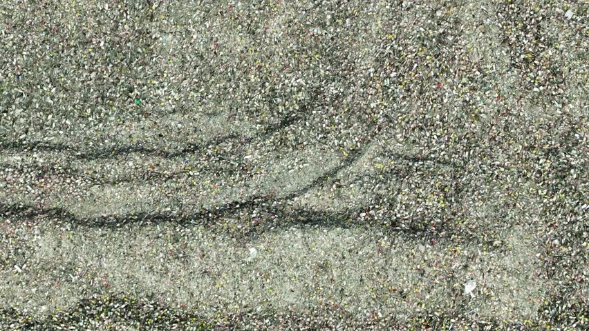 A bird's-eye view of glass waste, demonstrating the sorting and preparation process in a recycling plant for reuse in new glass products.
