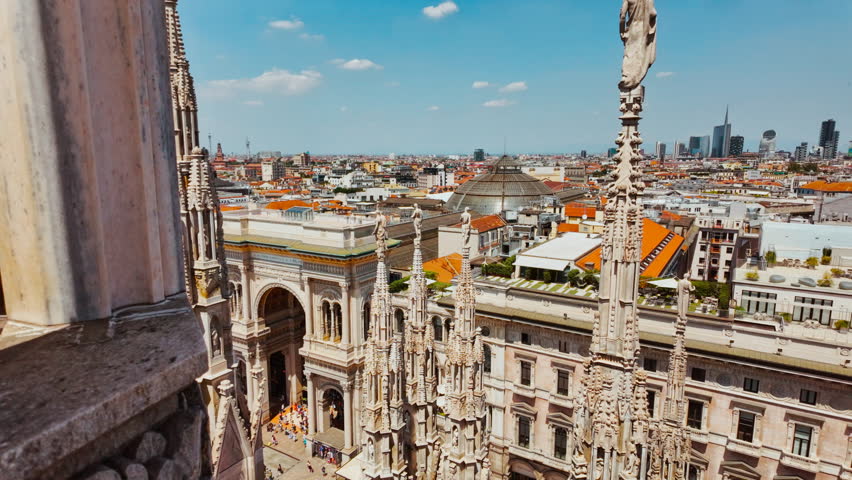 Iconic Galleria Vittorio Emanuele II glass dome and distant Milan skyline seen from above in Lombardy, Italy
