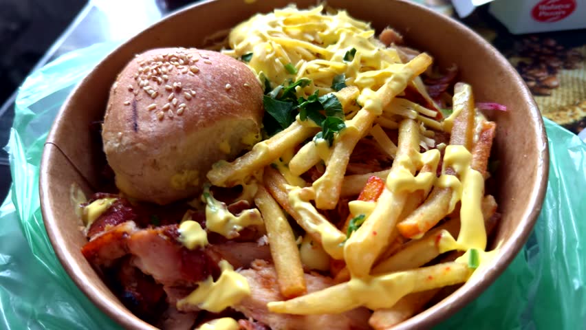 Delicious traditional Canadian dish  gravy and fries with cheese. Fried Potato. Poutine French Fries. Fast Food Hot Plate With Meat And Potato. Quebec Poutine Fries. Canadian Cuisine. Fat Food. 