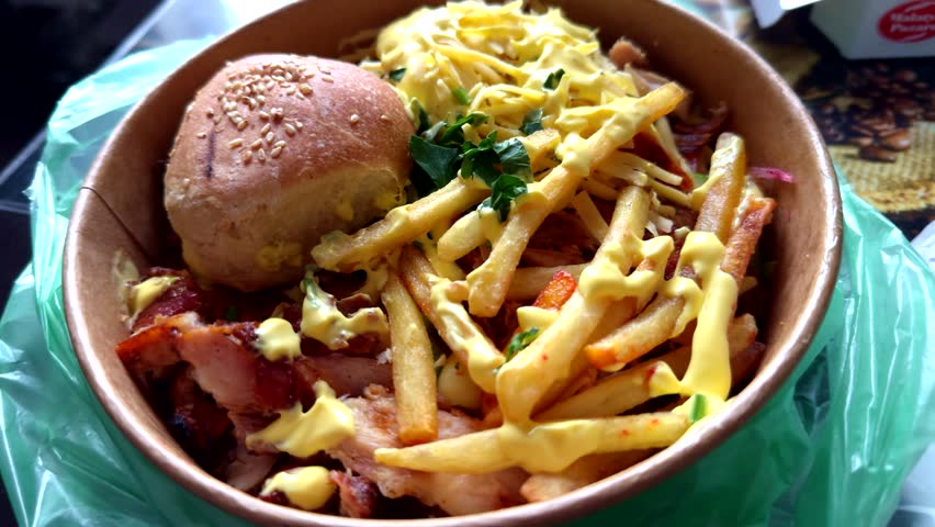 Delicious traditional Canadian dish  gravy and fries with cheese. Fried Potato. Poutine French Fries. Fast Food Hot Plate With Meat And Potato. Quebec Poutine Fries. Canadian Cuisine. Fat Food. 