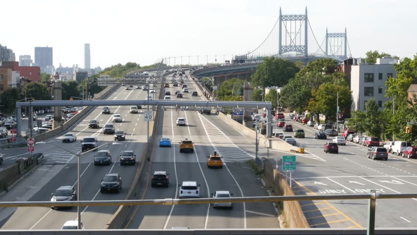 Triborough Bridge in Astoria, Robert F. Kennedy Bridge, New York City. Car traffic on road, multiple lane transport highway from elevated subway station in Queens near Ditmars Steinway, NYC, USA.