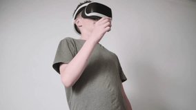 Teen boy standing in room, immersed in virtual reality headset game - Powered by Shutterstock - Get 15% off with code: PIKWIZARD15
