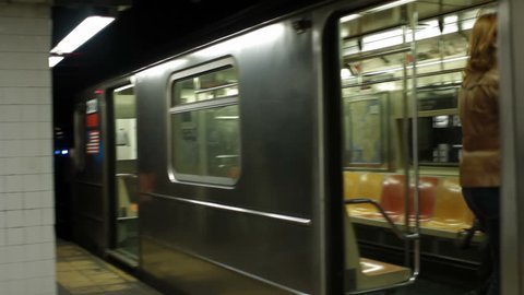 A woman runs for a New York subway train and just makes it.