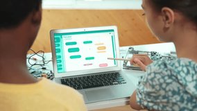 Laptop display coding system while student studying writing engineering code. Back view of diverse student learning programming system while pointing at screen at STEM technology class. Edification - Powered by Shutterstock - Get 15% off with code: PIKWIZARD15