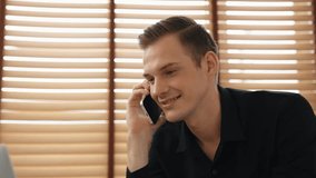 Happy businessman or salesman doing online business, remote working with laptop and making phone calls for sales at home. Telesales and modern business with communication. Adit - Powered by Shutterstock - Get 15% off with code: PIKWIZARD15