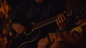 A cozy evening by the fire with guitar melodies. - Powered by Shutterstock - Get 15% off with code: PIKWIZARD15