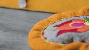 Close-up shot of a stitched pattern on top of a leather mitten, showcasing traditional Métis craftsmanship and detailed handiwork in Indigenous garment-making. Natural light and texture visible. - Powered by Shutterstock - Get 15% off with code: PIKWIZARD15