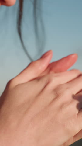 Close-up of a girl resting her head on hands in a heavyhearted moment, conveying deep sorrow . Her expression is filled with melancholy, as she gently holds clasped hands near face