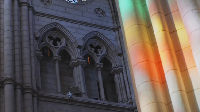 close up sunlight falls trough stained glass inside la almudena cathedral in madrid. slow camera movement