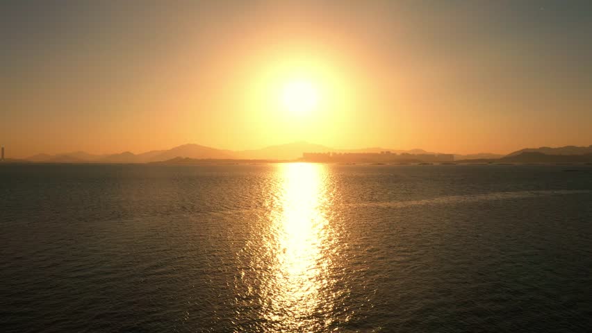 Beautiful early morning sunrise over tranquil sea in aerial view captures nature