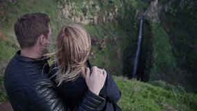 Tourists couple enjoying waterfall landscape - Powered by Shutterstock - Get 15% off with code: PIKWIZARD15