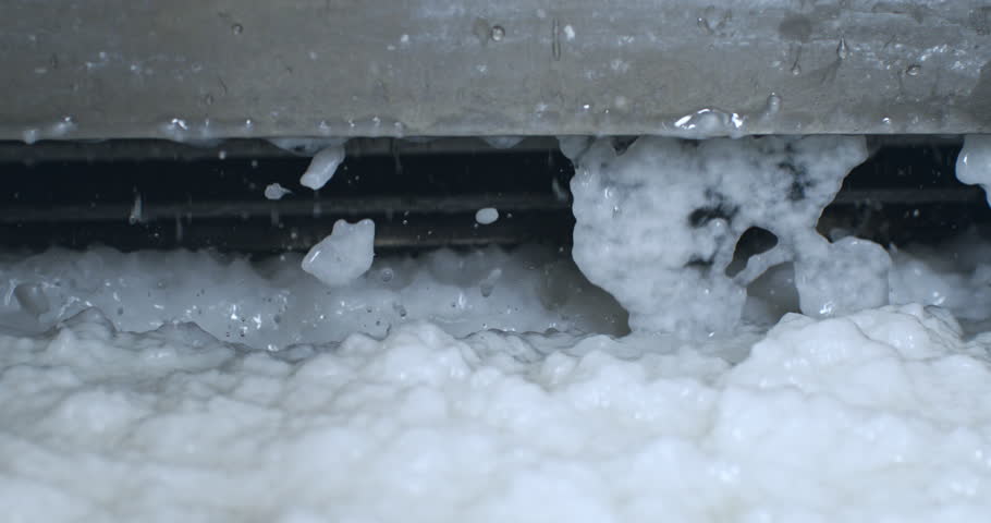 Super Slow Motion Close-Up of Wet Paper Pulp Dropping from Industrial Machine During Handmade Paper Manufacturing Process in Traditional Workshop Environment at 1000 fps.
