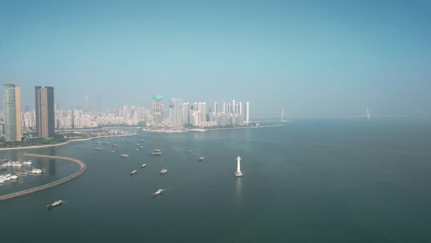 Live aerial view of ships moored in Shenzhen harbor showcasing urban skyline and coastal landscape