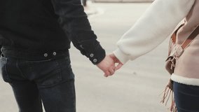 Happy couple in love, man and woman, holding hands and walking outdoors in winter. - Powered by Shutterstock - Get 15% off with code: PIKWIZARD15