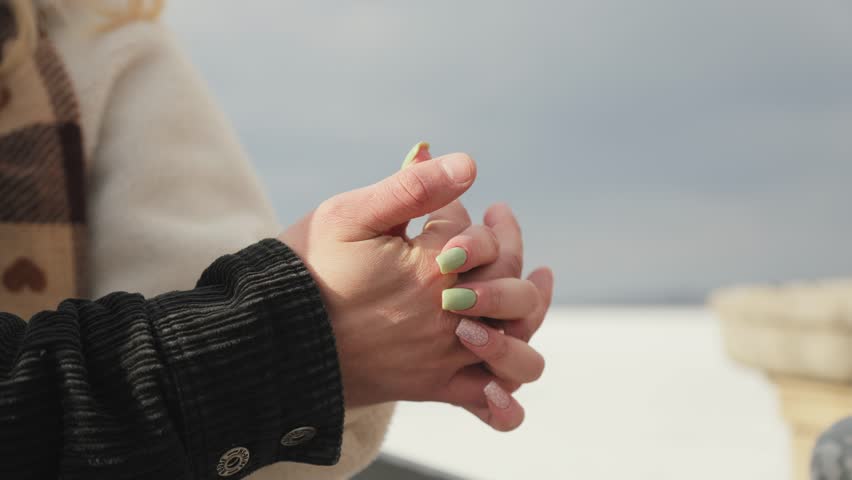 Happy couple in love having a good time in a winter park. The man gently holds the woman