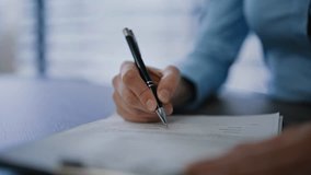 Businesswoman hand signing contract holding pen at office desk closeup. Unrecognizable woman manager putting signature on legal paper at workplace. Lady executive legalize financial agreement indoors. - Powered by Shutterstock - Get 15% off with code: PIKWIZARD15