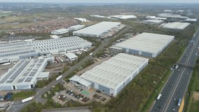 Drone footage of a large industrial park next to a busy motorway. Road, UK - Powered by Shutterstock - Get 15% off with code: PIKWIZARD15