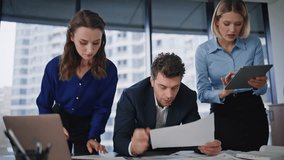 Group startupers examining report checking data on laptop in corporate office closeup. Enthusiastic three colleagues analyzing financial documents. Collaborative partners discussing business project. - Powered by Shutterstock - Get 15% off with code: PIKWIZARD15