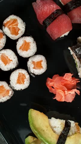Top View of Various Kind of Sushi Pieces with Camera Motion. Fresh Japanese Sushi, Asian Cuisine Concept. Placed on Black Stone Table.  Camera Placed on Motion Control System, Making Movement.