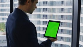 Manager tapping greenscreen tablet browsing online app at office window closeup zoom in. Elegant businessman touching mockup pad computer. Confident ceo reading financial data on chroma key gadget. - Powered by Shutterstock - Get 15% off with code: PIKWIZARD15