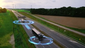 Aerial view of modern autonomous trucks scanning their surroundings with sensors. Self-driving vehicles controlled by artificial intelligence moving along the highway. Futuristic transportation. 4k. - Powered by Shutterstock - Get 15% off with code: PIKWIZARD15