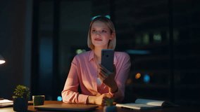 Smiling ceo looking smartphone at night office space closeup. Elegant businesswoman browsing banking app on cellphone sitting dark workplace. Successful manager receiving salary phone notification. - Powered by Shutterstock - Get 15% off with code: PIKWIZARD15
