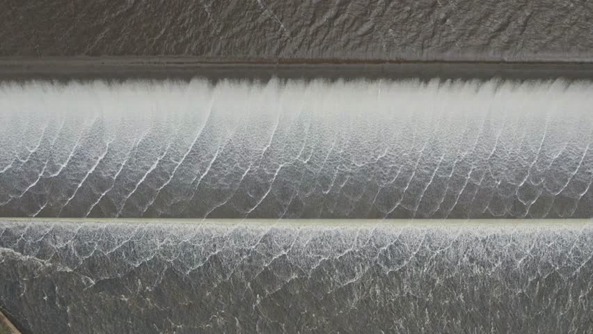 Close up view of water spilling over the Upper Coliban Reservoir spillway, central Victoria, Australia. October, 2022.