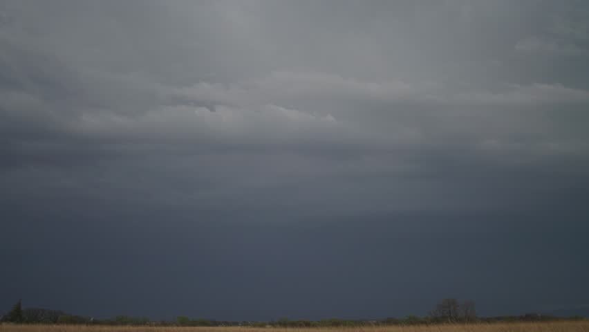 Lightning Flashing Through The Dark Clouds Before The Rainstorm. - wide shot