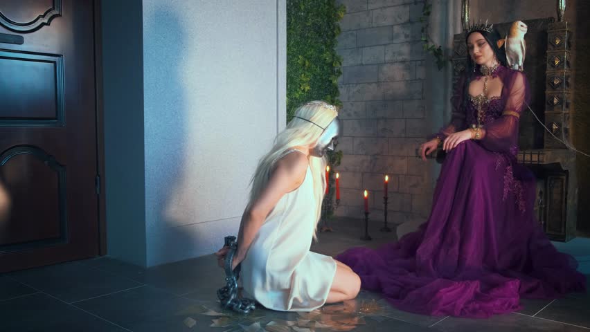 Artwork fantasy fairy evil insidious revenge woman queen sits on throne. Punishes captive slave girl princess metal chains. Shackles on hands, mask on face, kneels. Backdrop medieval ancient room. 4k