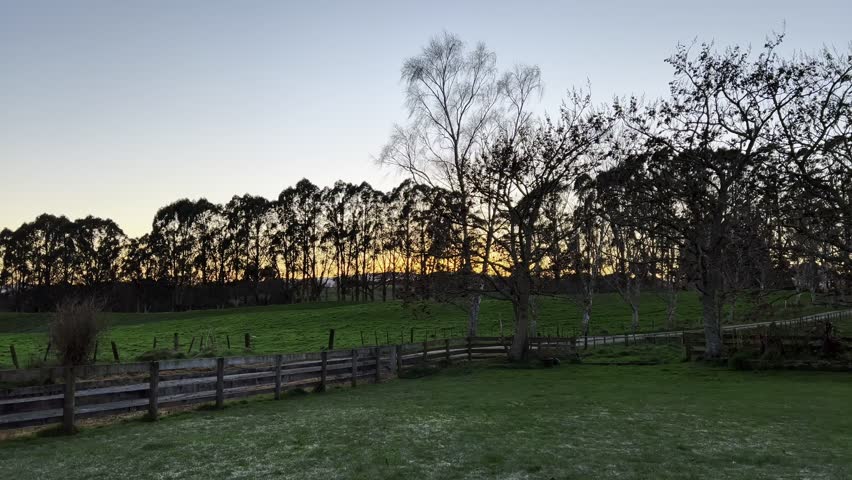 Scenic Sunset Farm Road and Fields Landscape with Wooden Fences