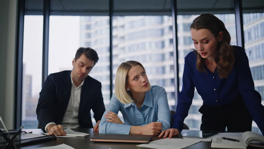 Businesswoman shouting at office colleagues dissatisfied project failure in conference room closeup. Angry woman boss complaining on financial results. Nervous coworkers solving startup problem crisis