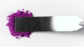 Purple eyeshadow cosmetics texture with spatula on white background. Makeup products texture close-up, cosmetic product close-up,  4k motion. Cosmetic swatch of eyeshadows. Painters pigment - Powered by Shutterstock - Get 15% off with code: PIKWIZARD15