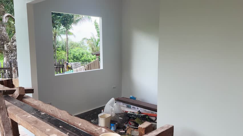 Blogger shows restored enclosure with building supplies at home POV. Man conducts room tour for followers in renovating suburban cottage house