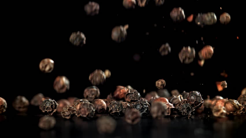 Black pepper falls on the table. Filmed on a high-speed camera at 1000 fps. High quality FullHD footage