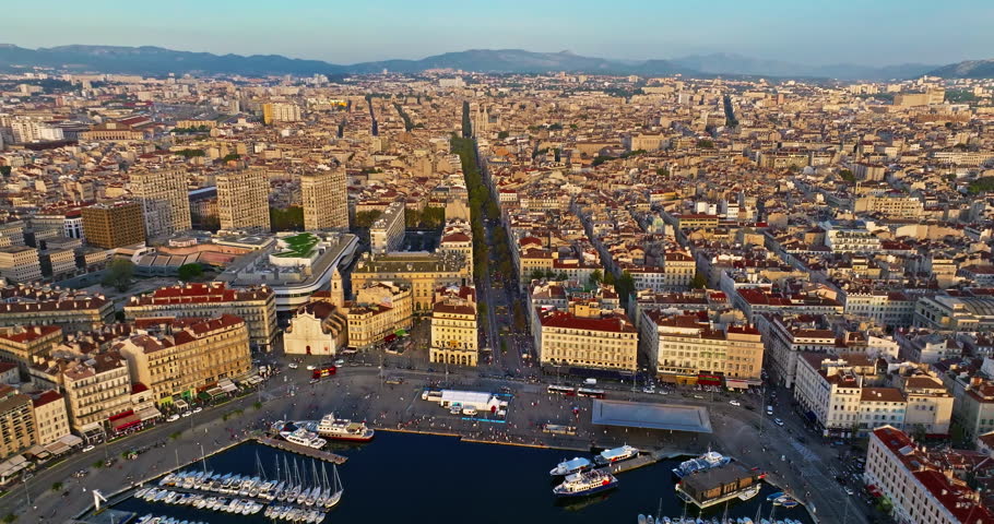 Aerial view of the city of Marseille in the morning sun. Rooftops in French Town. Crowds of people stroll through the coastal town. Drone view of Marseille in the south of France