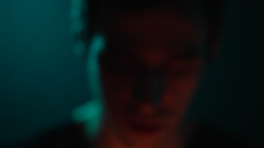 A man lights a match in the dark