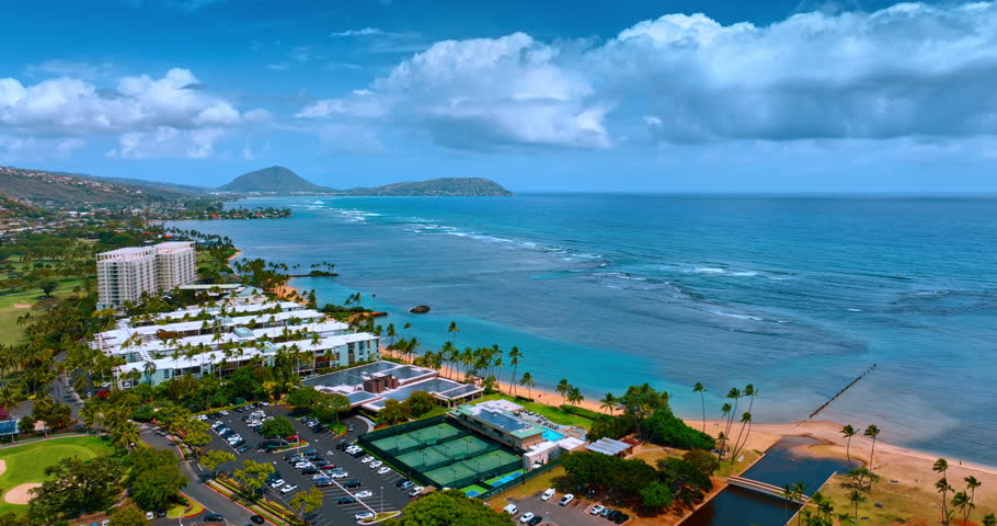 Approaching picturesque beach and waterscape of the azure ocean. Stunning coast of Honolulu, Hawaii, USA. Top view.