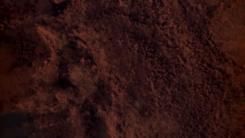 The cocoa powder flies up and down. Filmed on a high-speed camera at 1000 fps. High quality FullHD footage