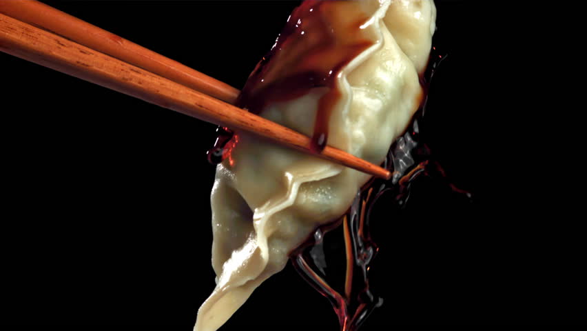 Soy sauce is poured over the gyoze dumplings. Filmed on a high-speed camera at 1000 fps. High quality FullHD footage