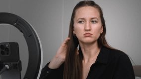 Young woman influencer recording video blog while creating content, using ring light for professional illumination and engaging social media followers from home setting - Powered by Shutterstock - Get 15% off with code: PIKWIZARD15